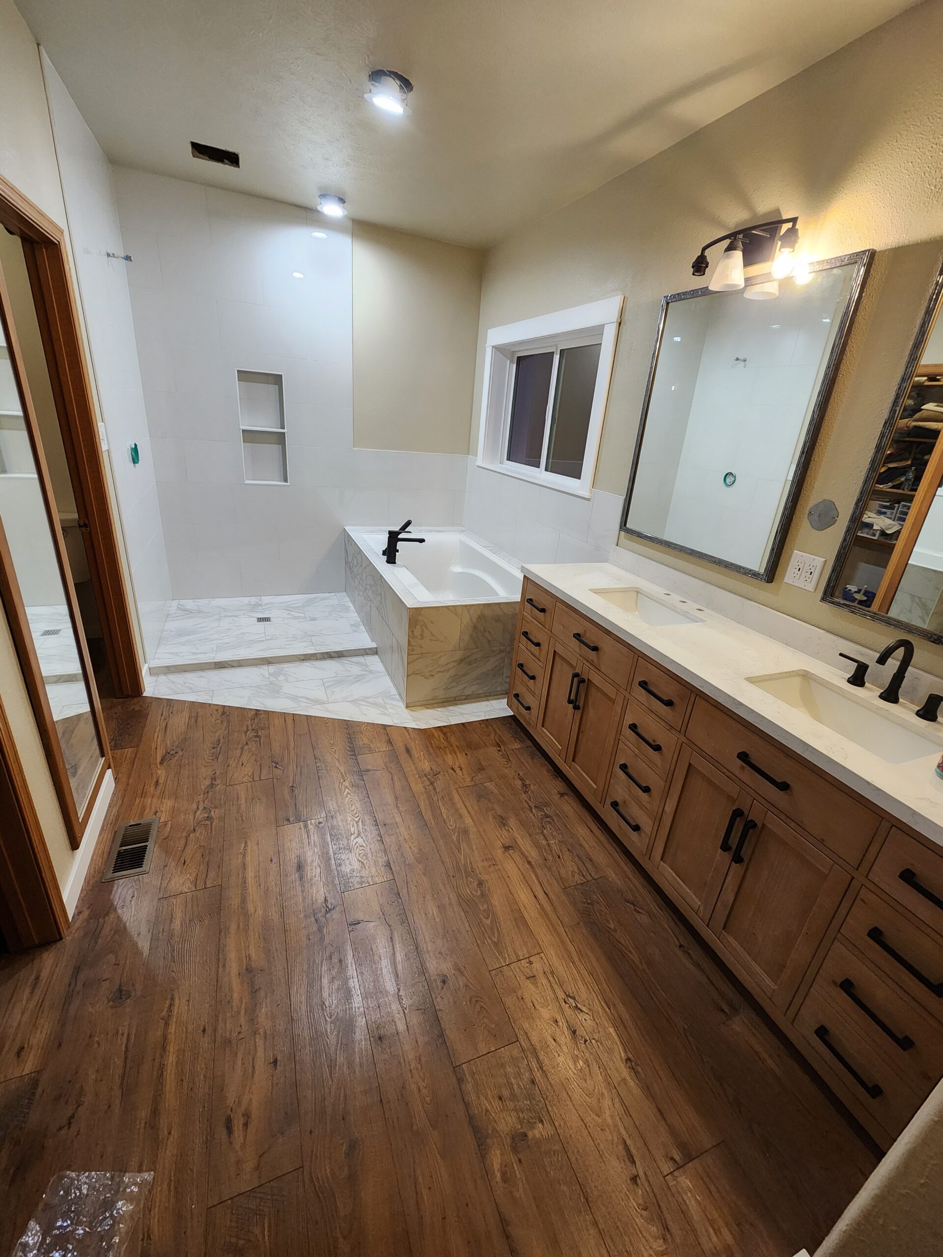 Bathroom renovation with modern tile work and updated vanity