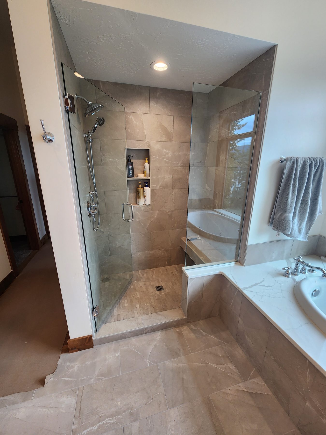 Bathroom remodel with glass shower enclosure and soaking tub