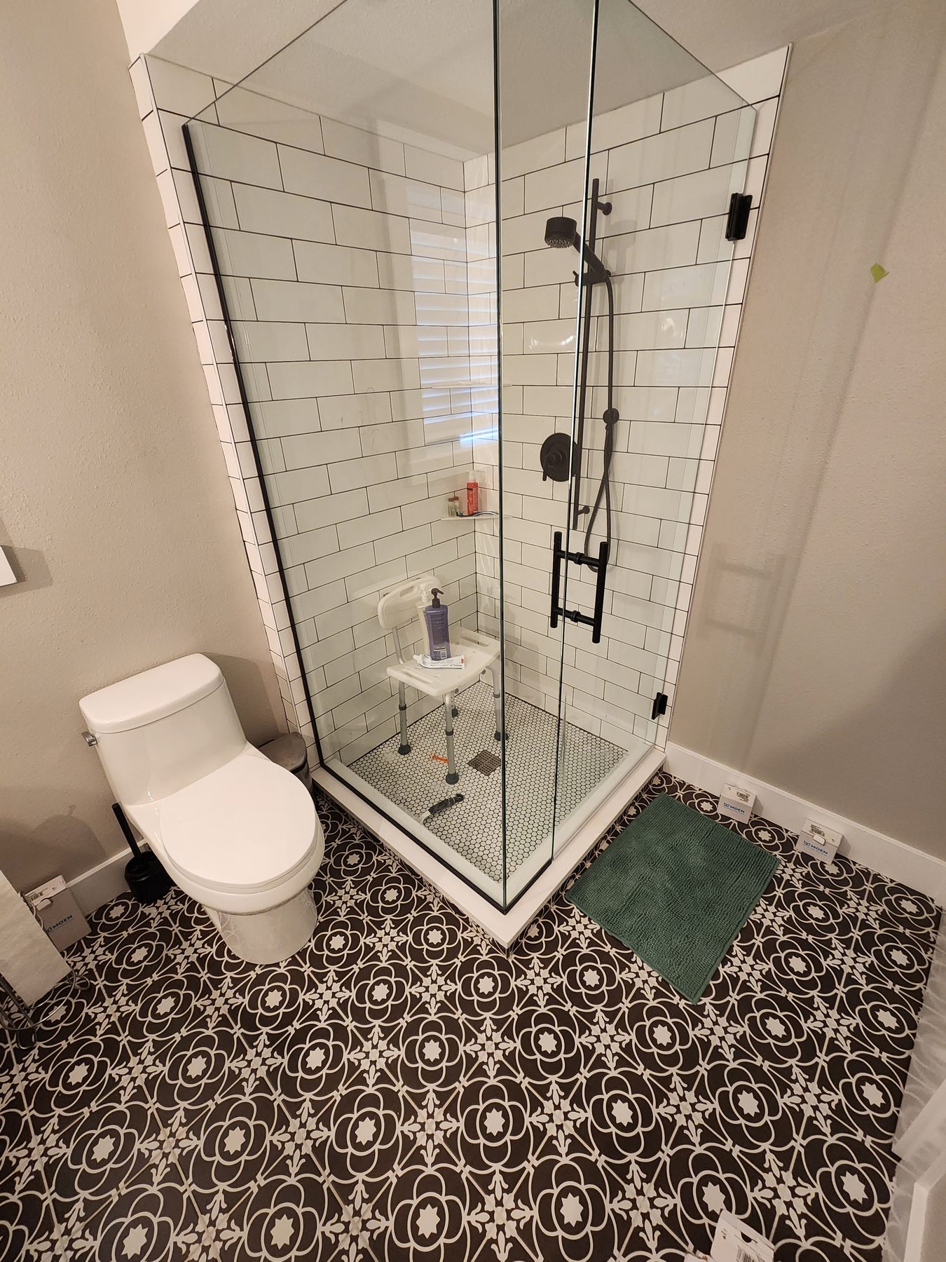 Bathroom remodel with subway tile shower and patterned floor tile