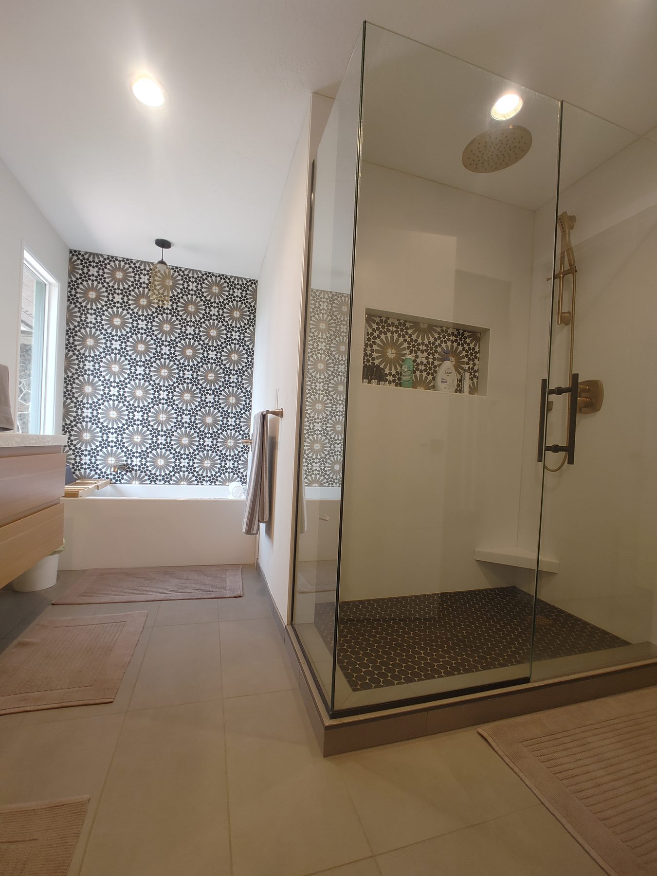 Bathroom remodel with walk-in shower and patterned tile feature wall