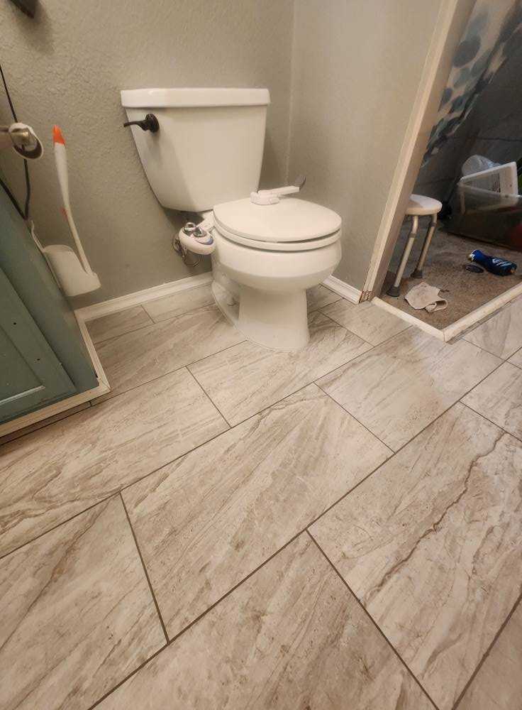 Patterned tile bathroom floor detail with grout line work