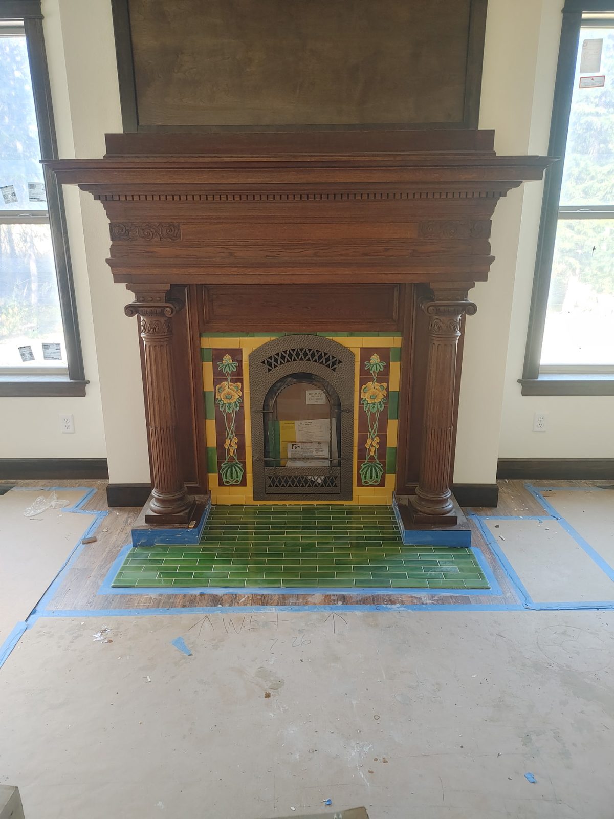 Restored antique carved-wood Victorian mantel with decorative majolica art tile