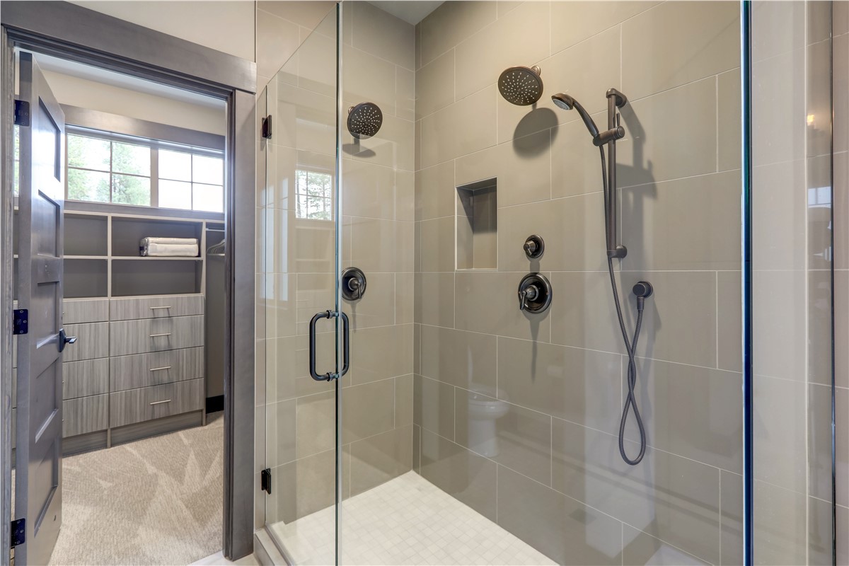 Custom walk-in shower with tile walls and glass enclosure