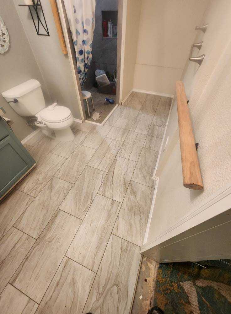 Walk-in shower with frameless glass and custom tile work